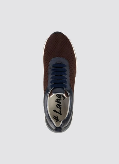 Top view of a brown mesh sneaker with navy laces and white sole on a plain background 