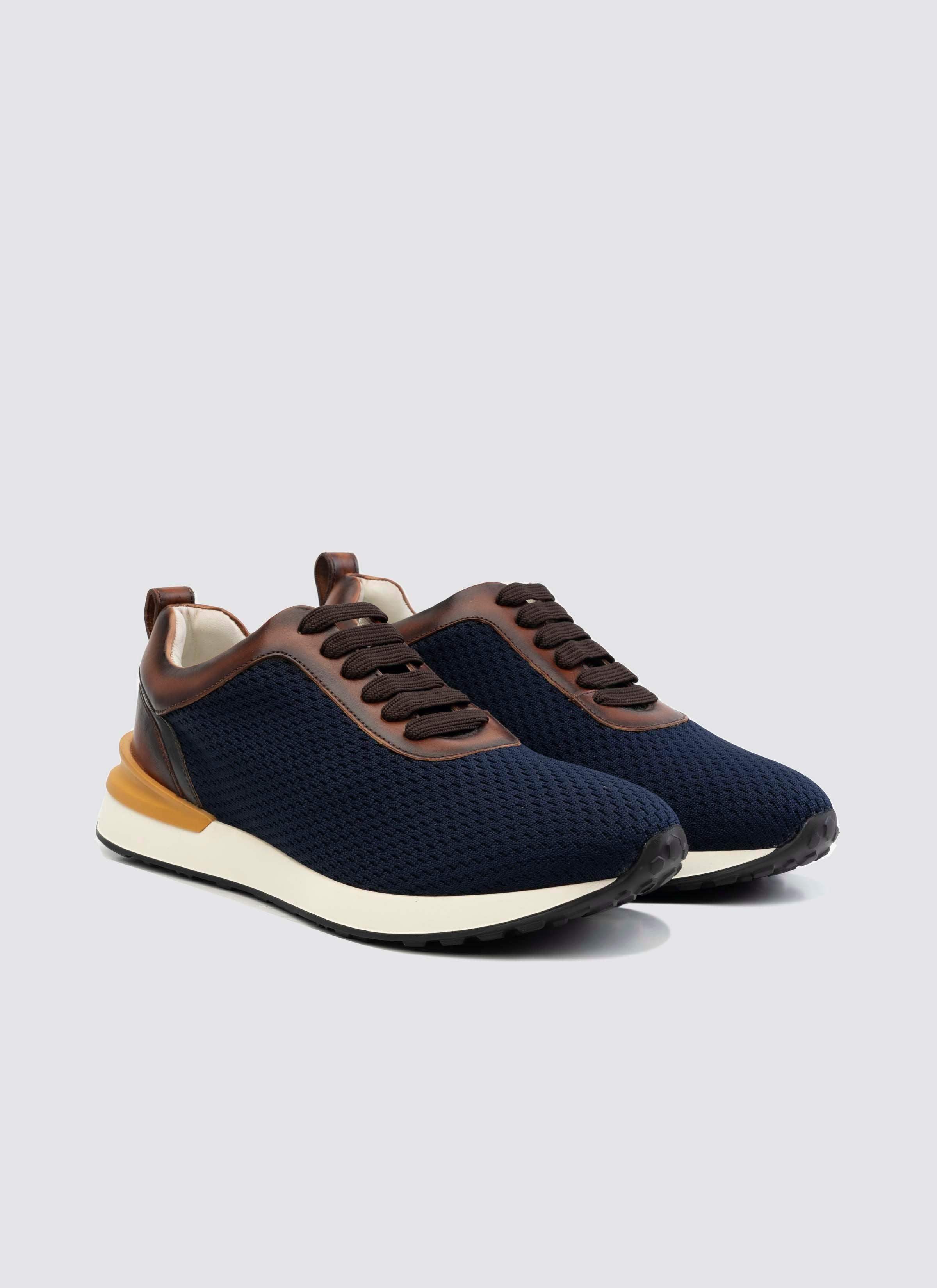 Men's navy blue mesh sneakers with brown leather accents and white soles 