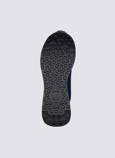 Close-up of black sneaker sole with textured hexagonal and geometric grip pattern 