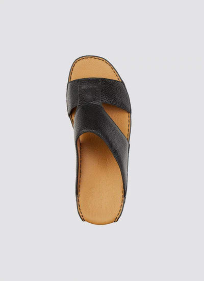 Black leather men’s slide sandal with cross strap and tan footbed, top view 