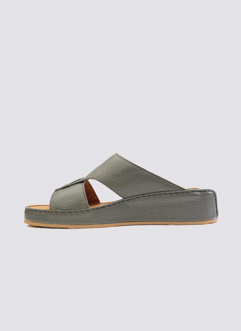 Grey leather slip-on sandal with open toe, cross strap design, and flat sole on white background 