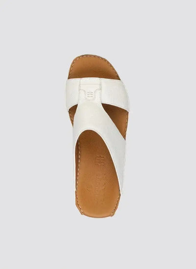 White leather slip-on sandal with criss-cross straps and tan footbed, top view 