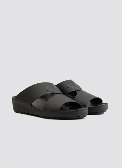 Black men's leather slip-on sandals with open toe and cut-out strap design on a gray background 