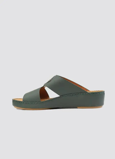 Green leather women's wedge sandal with open toe and criss-cross straps on white background 