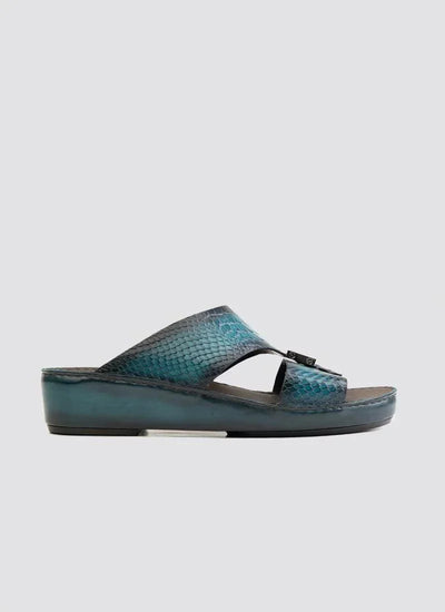 Turquoise textured leather men's slide sandal with platform sole on light background