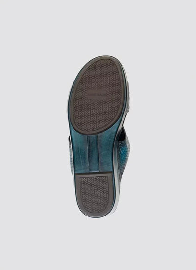 Close-up of turquoise textured men's loafer shoe sole on light background