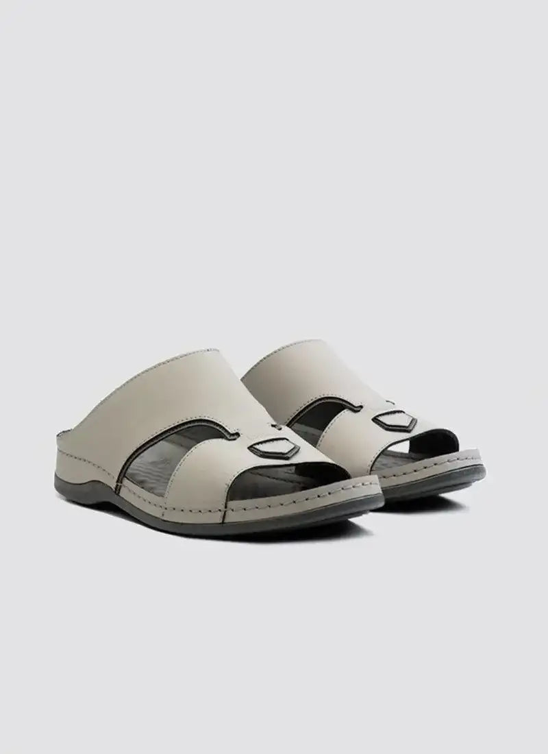 Pair of men's grey leather open-toe sandals with cutout design on white background 