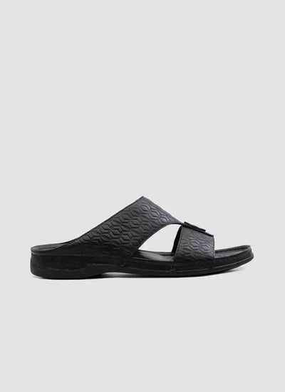 Black men's slide sandal with textured geometric pattern on sole and straps, side view 