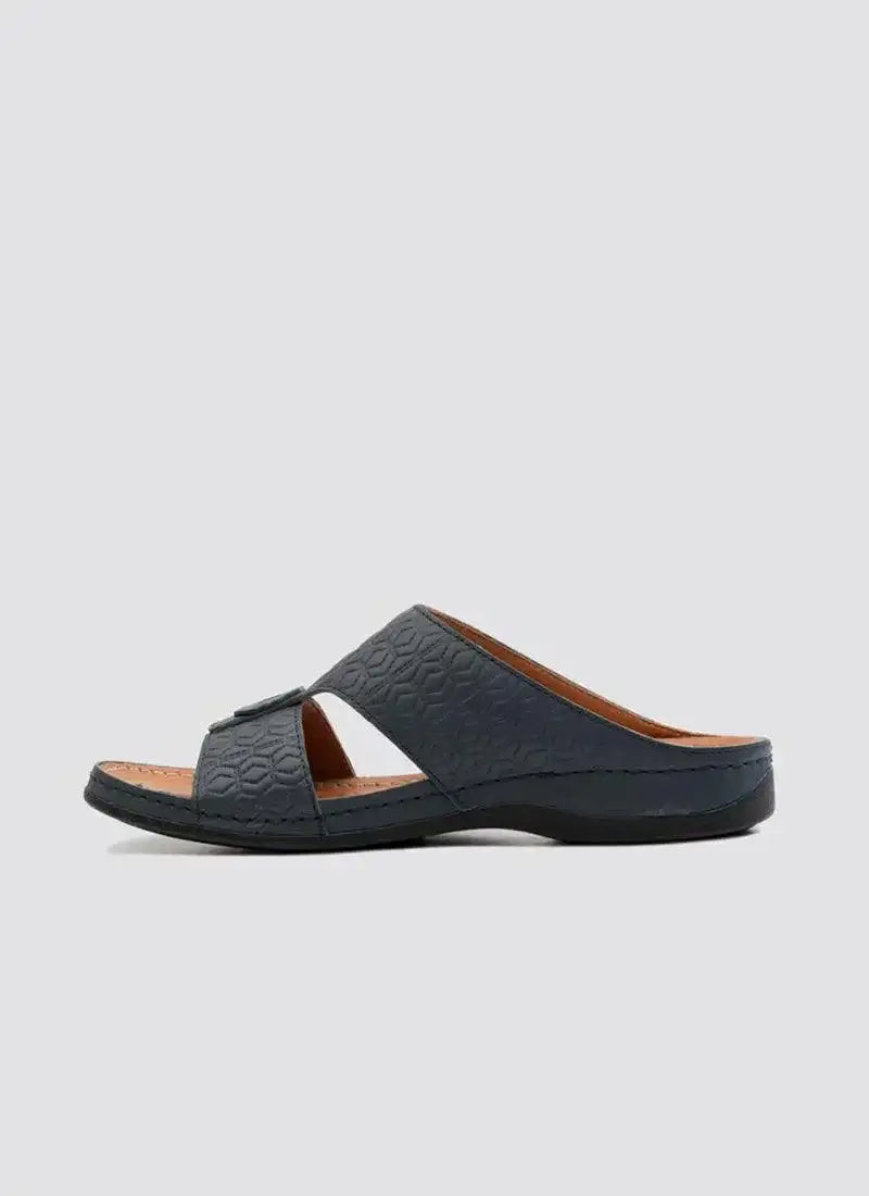 Navy blue men's leather slip-on sandal with textured cross strap on white background 