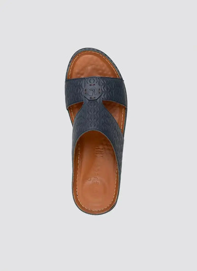 Men's navy blue leather slip-on sandal with embossed pattern and tan footbed 