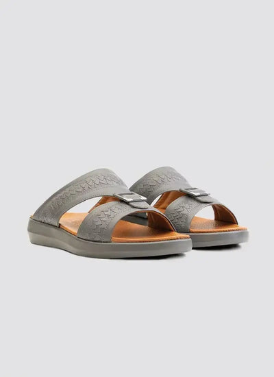 Men's grey leather slip-on sandals with buckle detail and textured straps on white background 