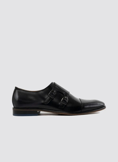 Men's black leather double monk strap dress shoe with cap toe on light background 