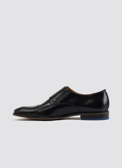 Men's black leather slip-on dress shoe with cap toe and low heel on white background 