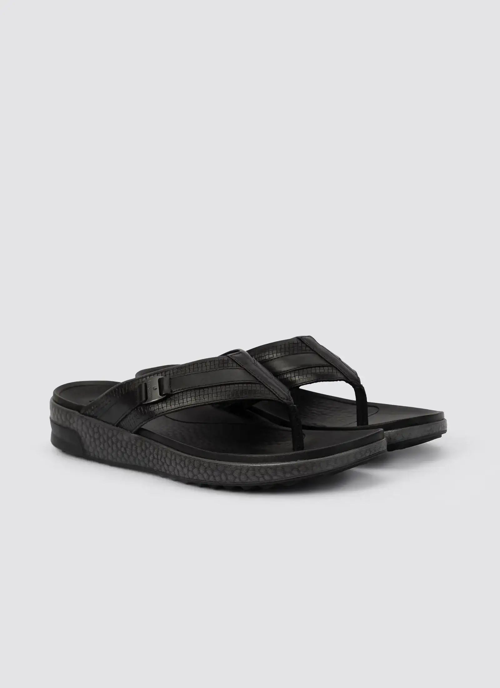 Men's black leather thong sandals with textured straps and cushioned sole on white background 