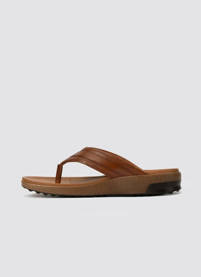 Men's tan brown leather flip-flop sandal with textured sole, side view on white background.  