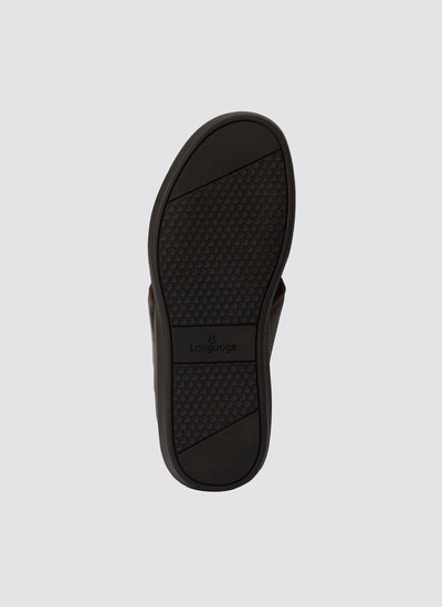 Black sandal sole with brand logo on a light gray background 