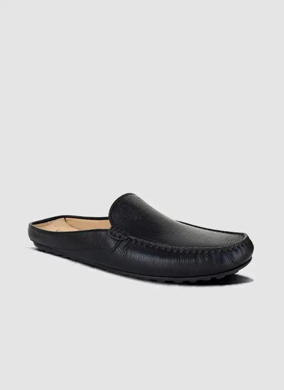 Men's black leather slip-on loafer with stitched detailing, side view on grey background 