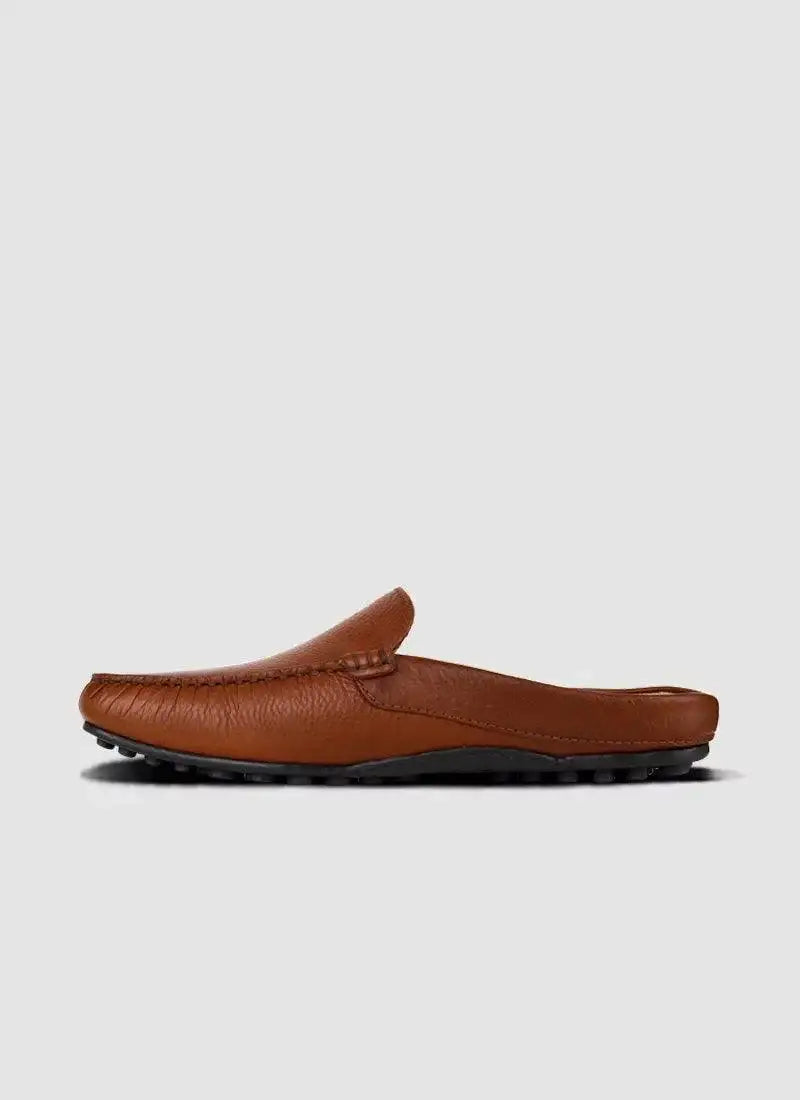 Tan leather slip-on loafer for men with textured sole, side profile on white background 