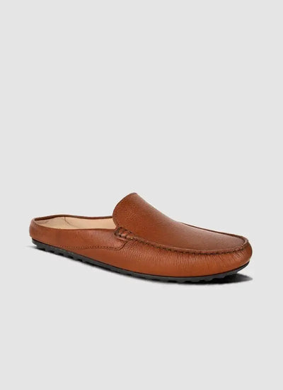 Tan leather men's loafer mule with textured upper and rubber sole on light background 