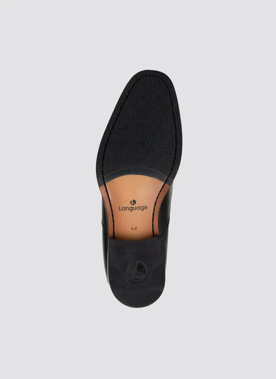 Top view of black leather loafer with textured sole and size 42 marking 