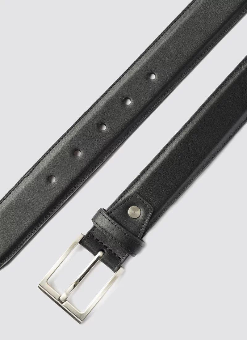 Black leather belt for men with silver buckle on light background 