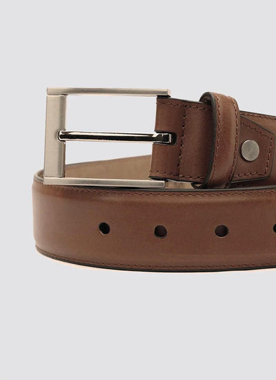 Men's brown leather belt with silver buckle on light background 