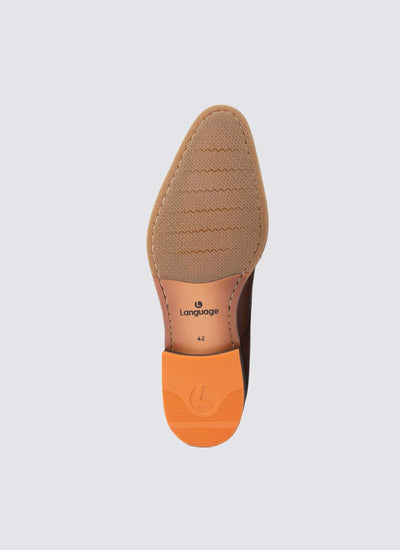 Tan dress shoe sole with textured grip and orange heel, size 42, on light background  