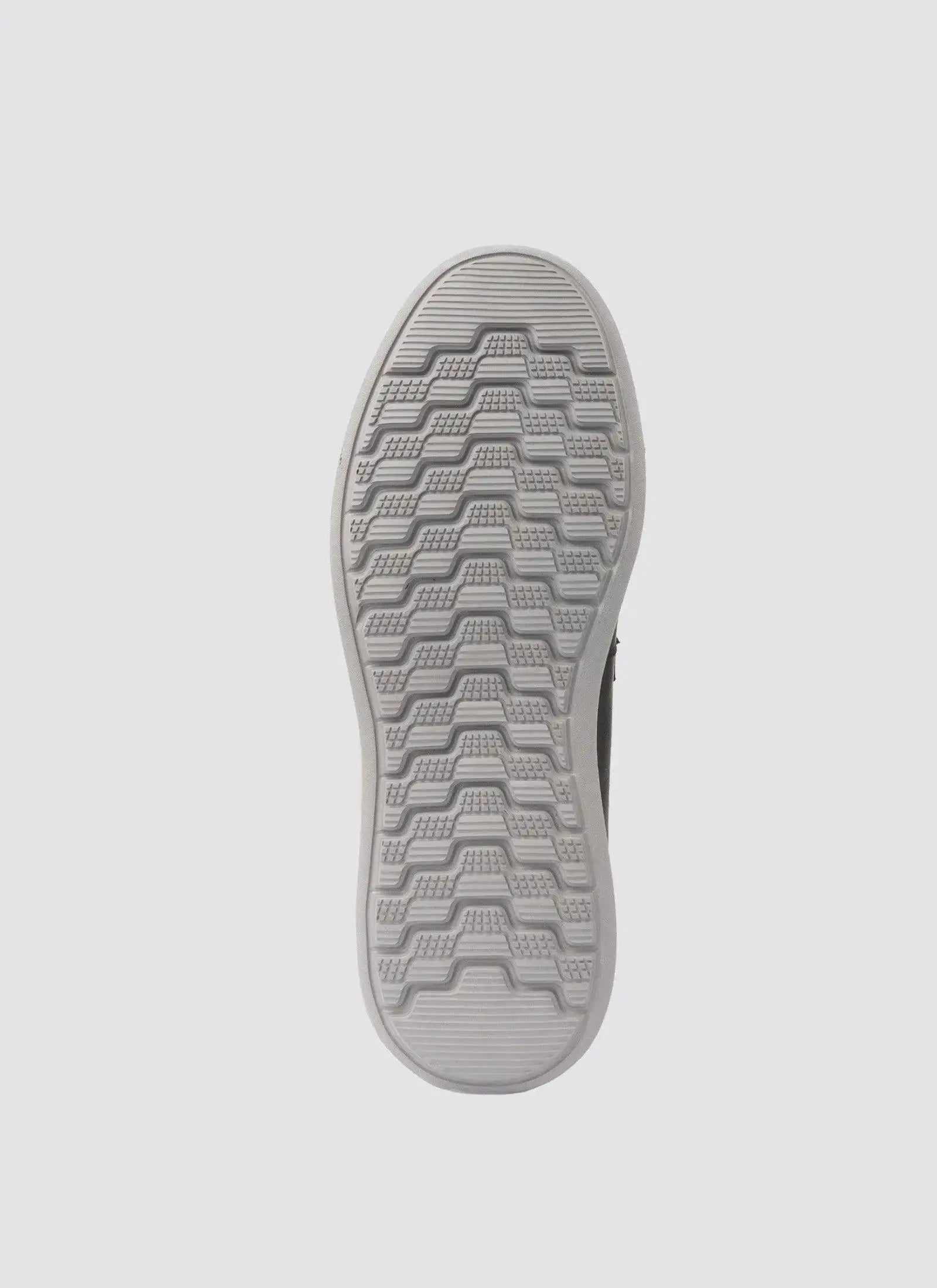 Grey rubber shoe sole with textured, non-slip tread pattern on white background 
