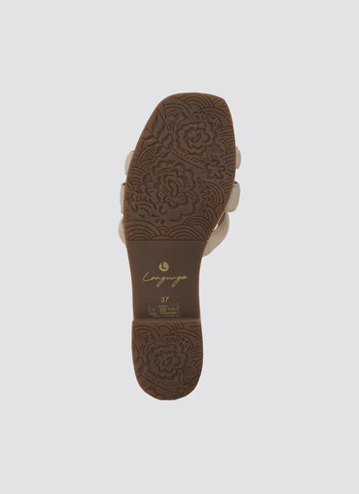 Close-up of nude sandal sole with floral textured grip, size 37, against white background  