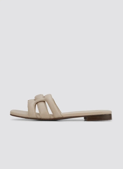 Nude flat slip-on sandal with open toe and padded straps for women on white background  