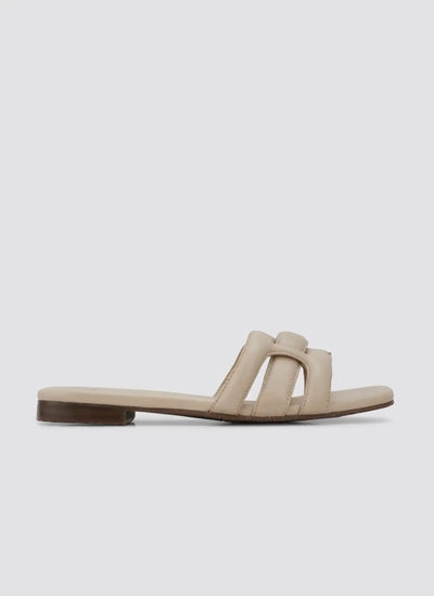Beige women's flat sandal with open toe and cushioned straps on a white background 