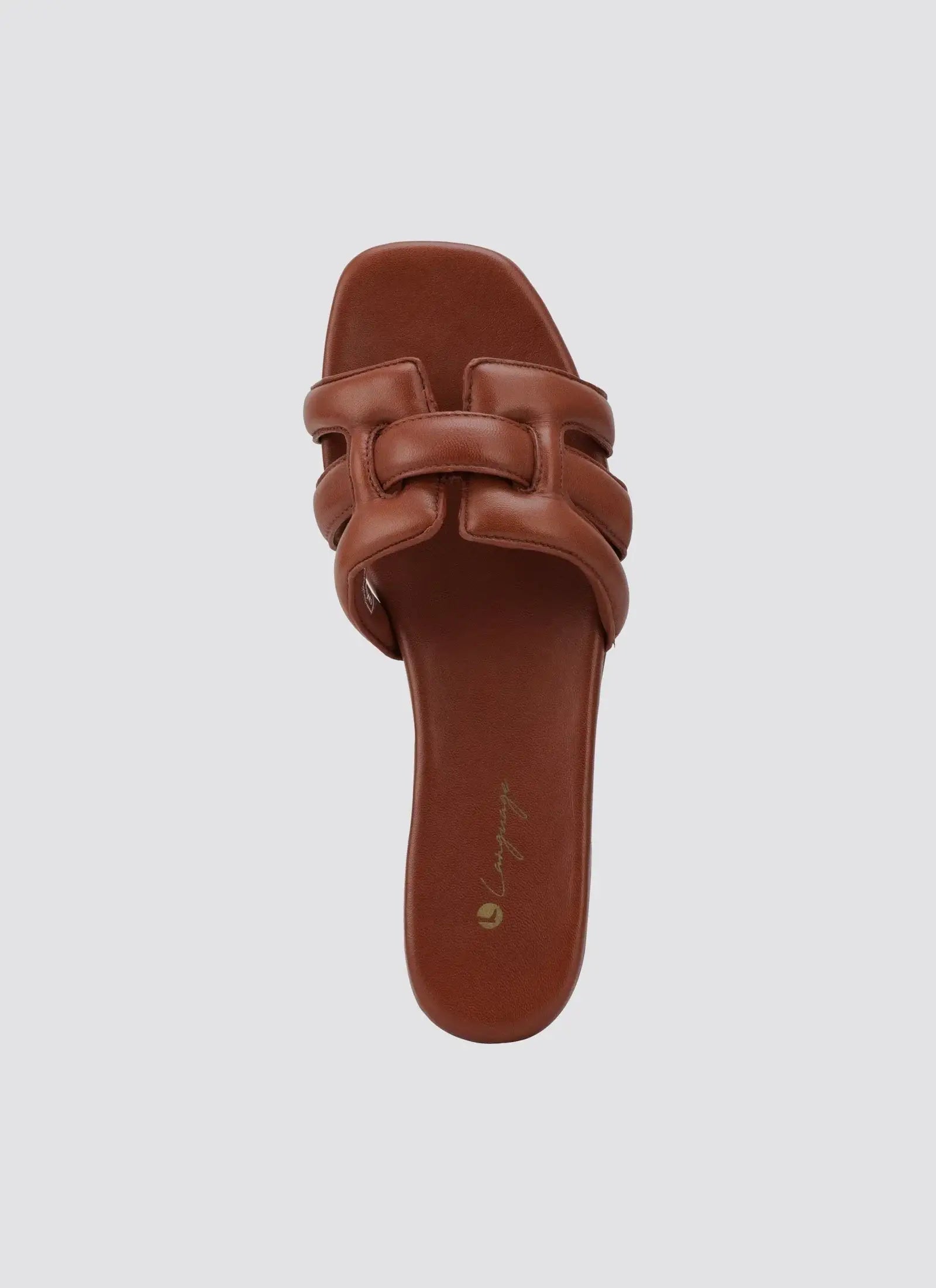Tan leather women's slide sandal with padded woven straps and square toe on white background 