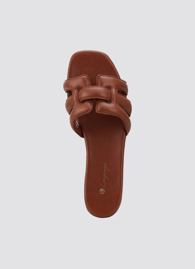 Tan leather women's slide sandal with padded woven straps and square toe on white background 
