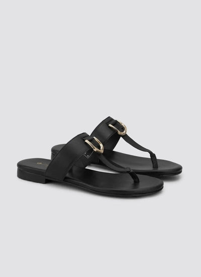 Black leather sandals with gold buckles and toe loop, flat sole, angled perspective 