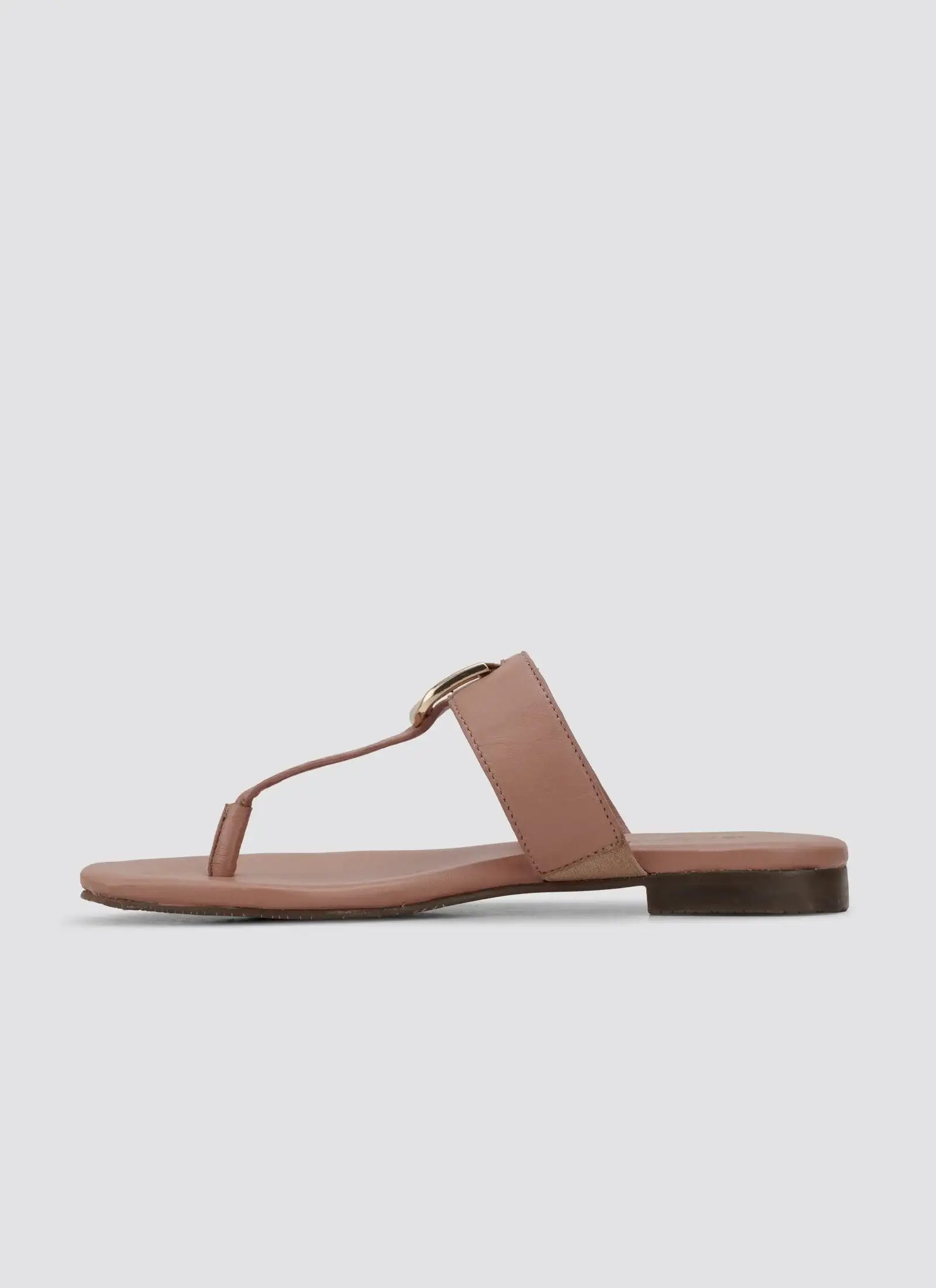 Women's pink leather flat sandal with toe loop and gold buckle, side view 