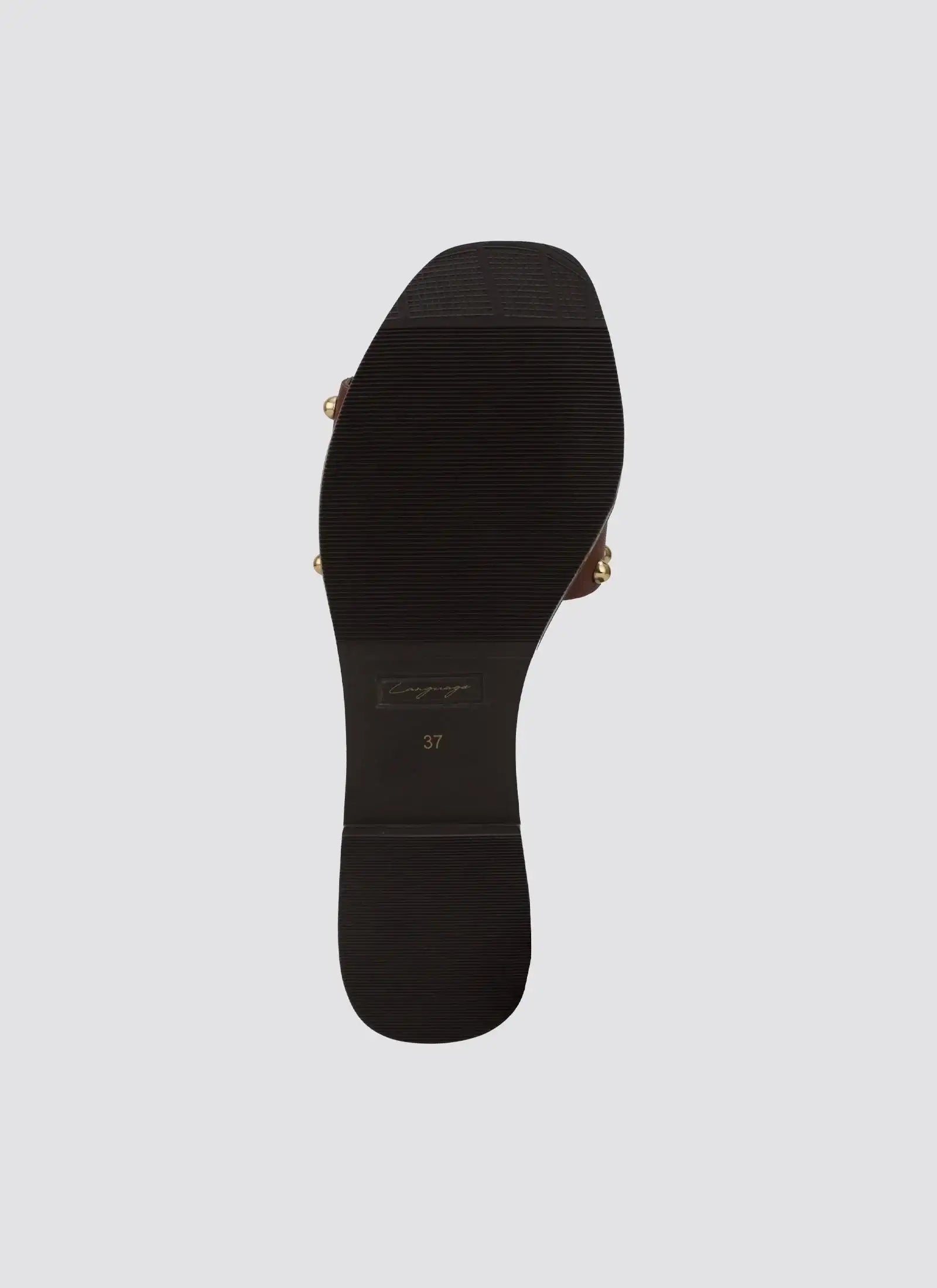 Black rubber sole of a women's cognac sandal, size 37, with gold accents on sides 