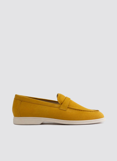 Mustard yellow suede loafer with white sole for men, side view on white background  
