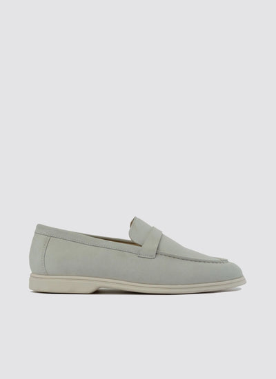 Off-white suede men's loafer with penny strap and low heel on plain background 