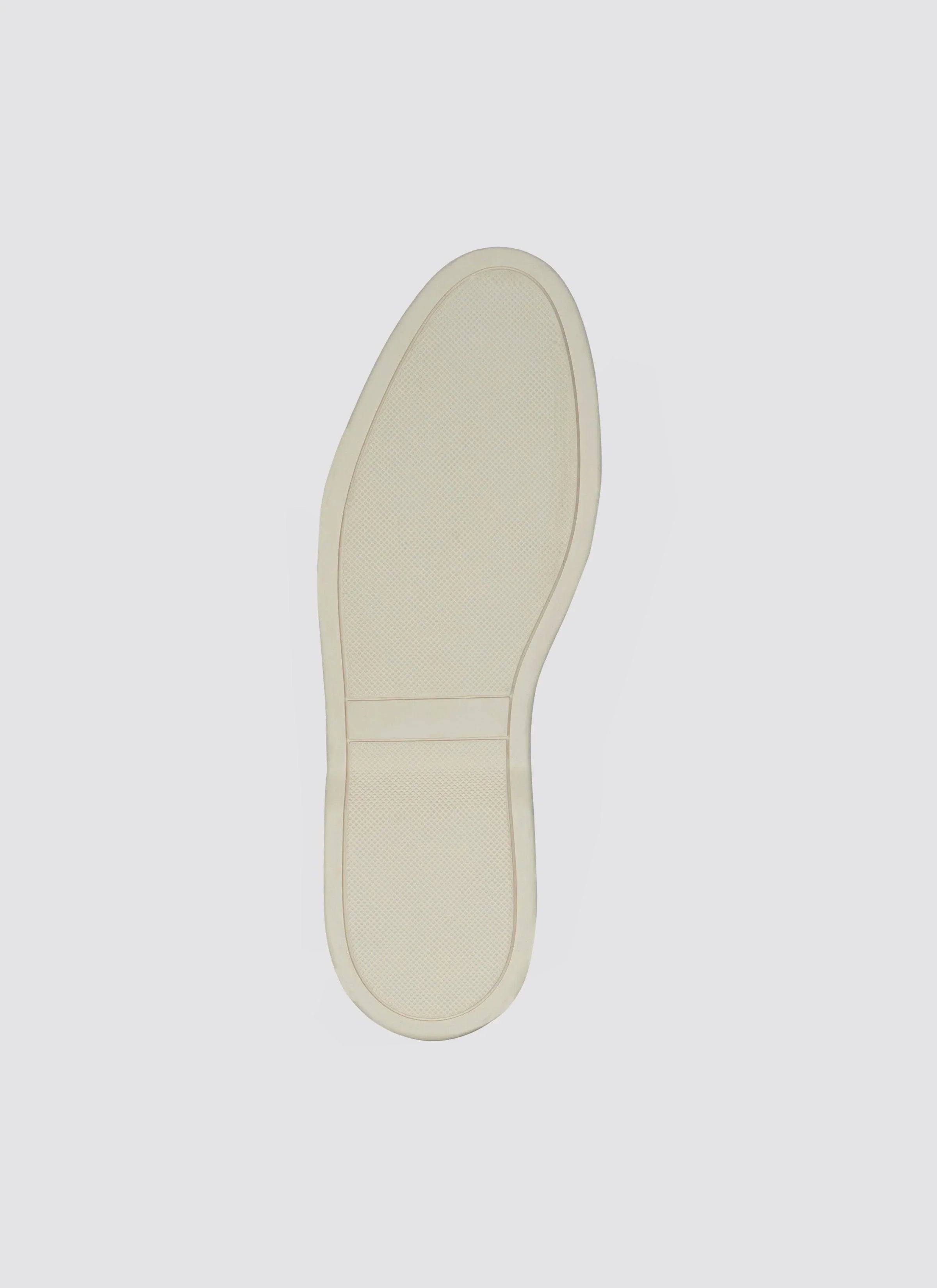 off-white textured shoe sole with slip-resistant grip, isolated on white background  