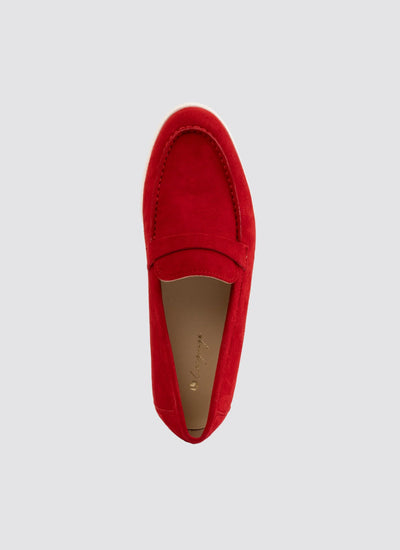 Red suede loafer for men or women, slip-on footwear on light grey background 
