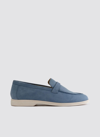 Light blue suede loafer with white sole, casual men's footwear on plain background 