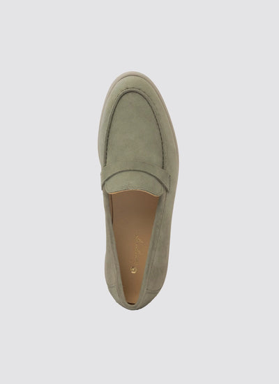 Top view of a men's light olive suede loafer with stitched detailing on a plain background 