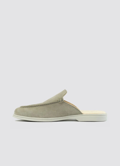 Light olive green suede slip-on loafer mule with white sole, side view on white background. 