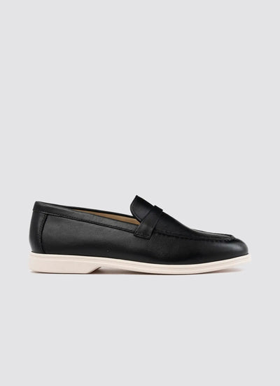 Pair of black leather shoes with buckle design on a light gray background 