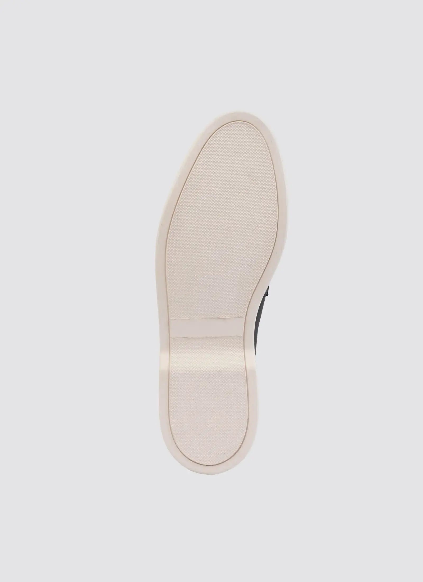 Close-up of a beige shoe sole on a light gray background 