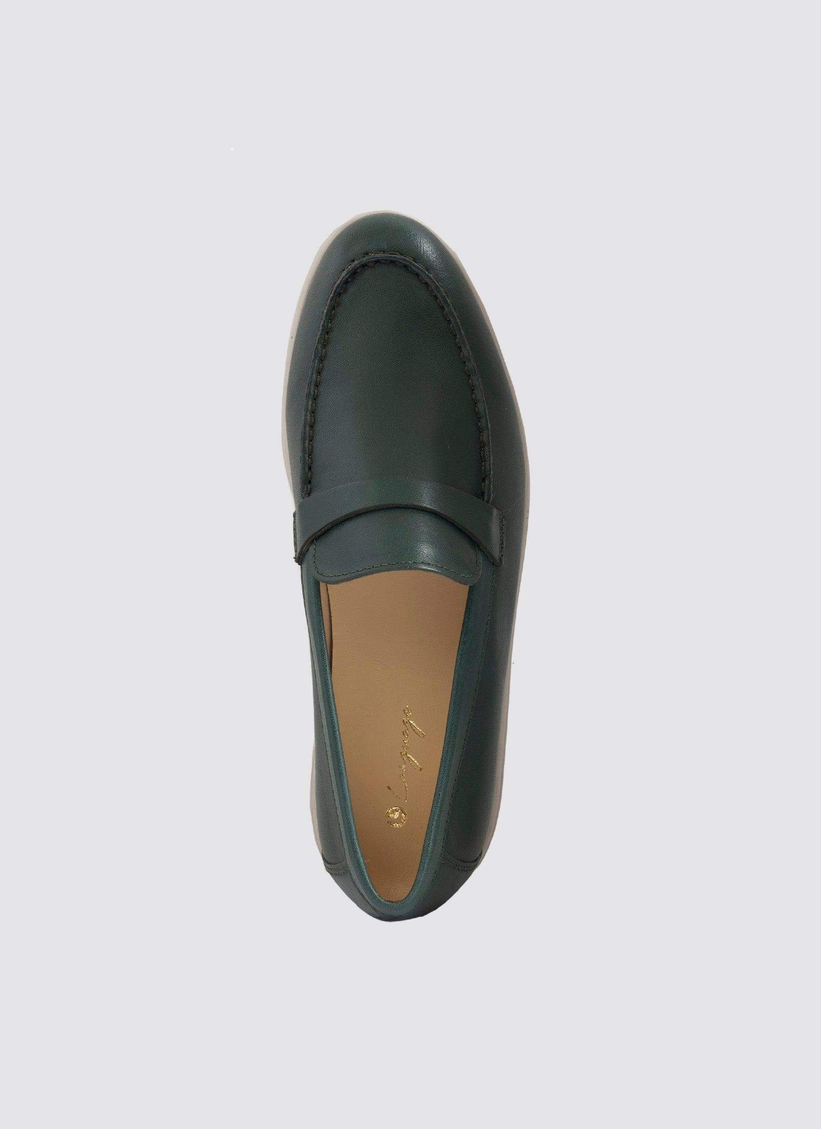 Top view of a forest green leather loafer shoe with stitched detailing on a plain background 