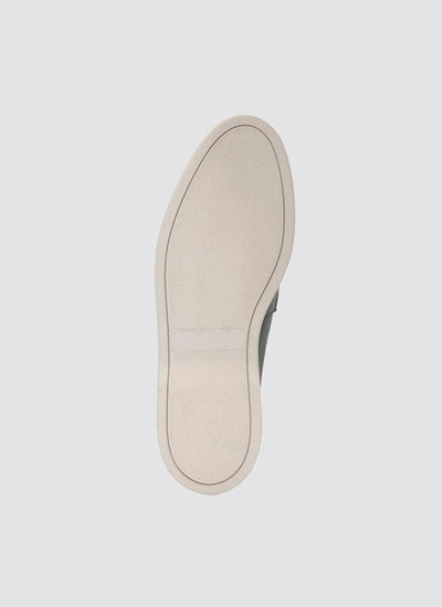 Beige rubber sneaker sole with textured grip, photographed against a plain background. 