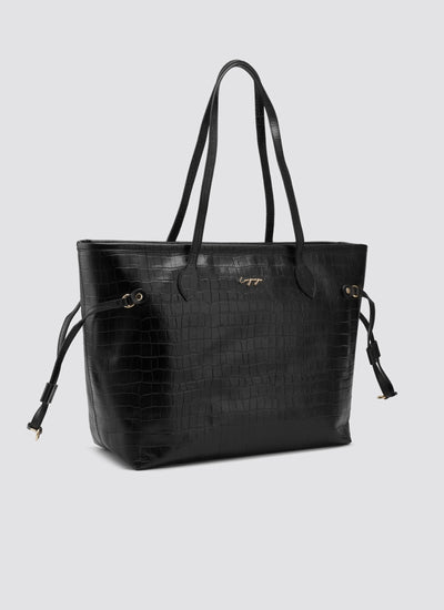 Black handbag with a textured pattern on a light gray background 