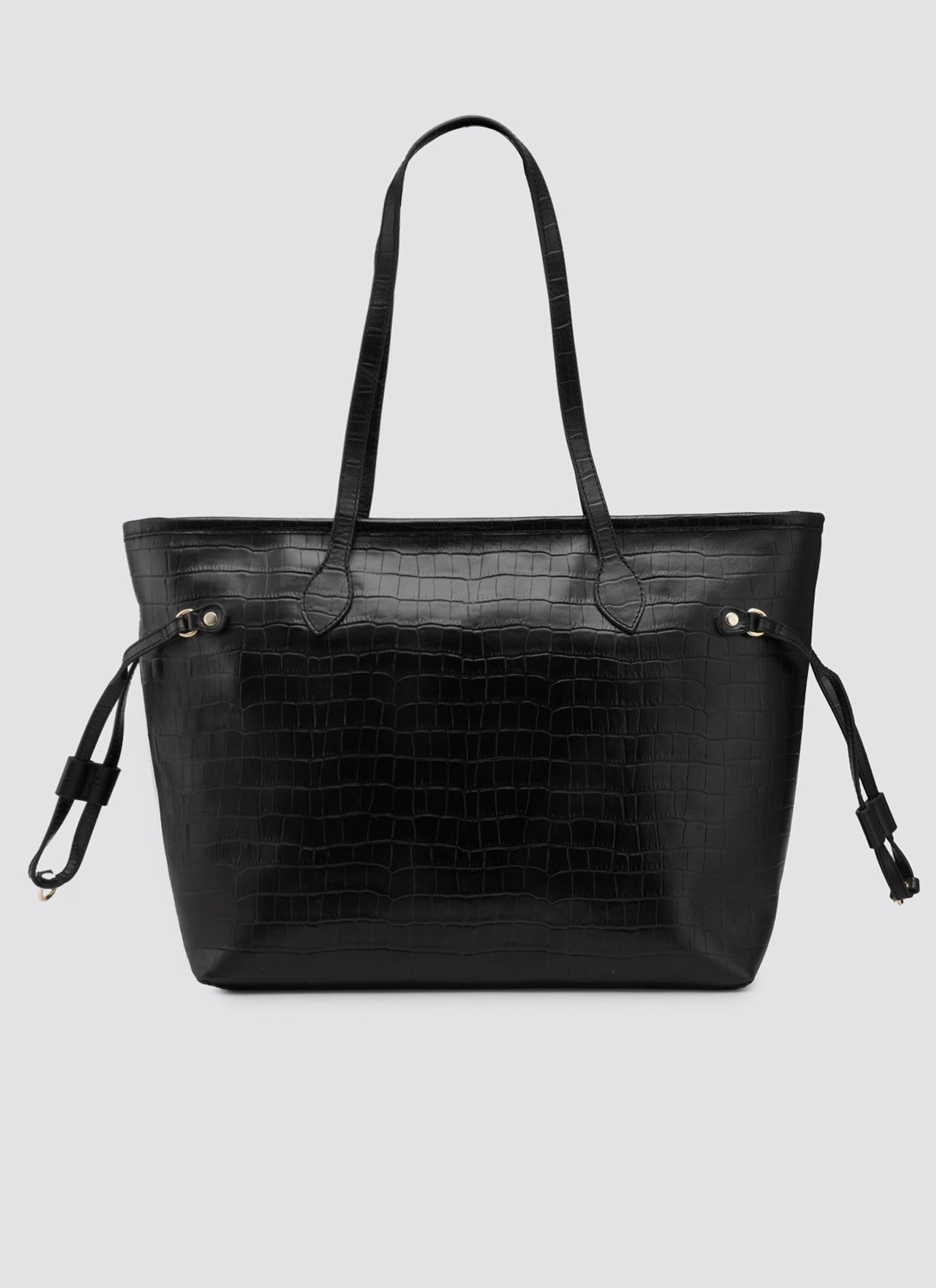 Black handbag with crocodile texture on a light gray background 