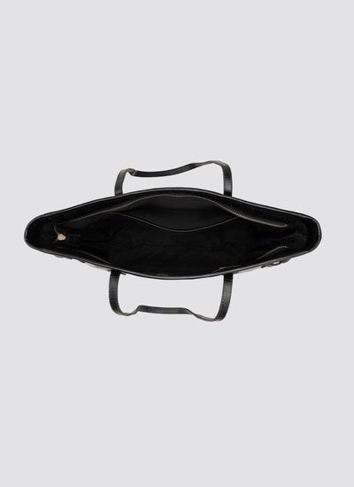 Black metal tray with handles on a light gray background 